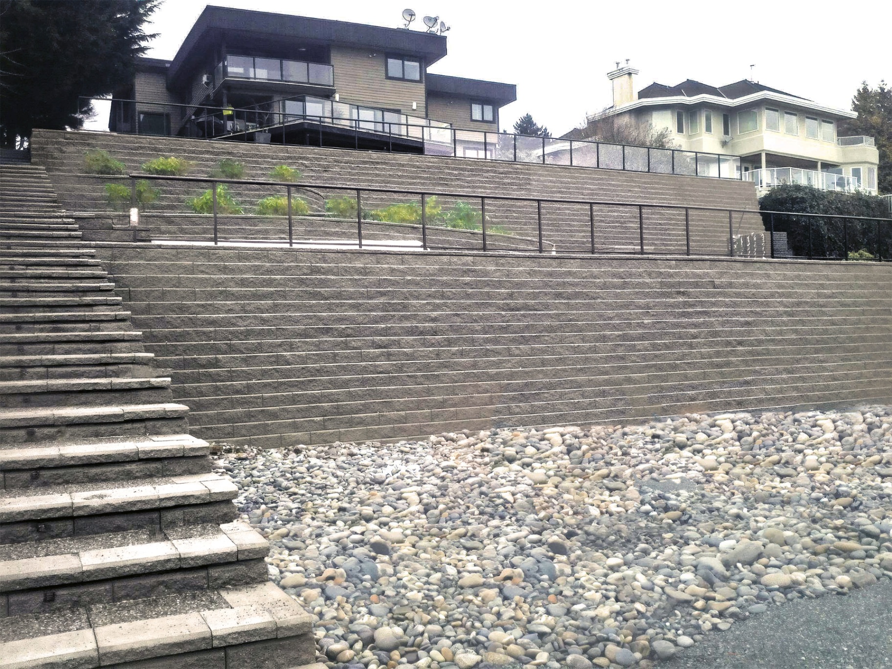Looking up the full height of the Panorama Ridge retaining wall from the river-rock base