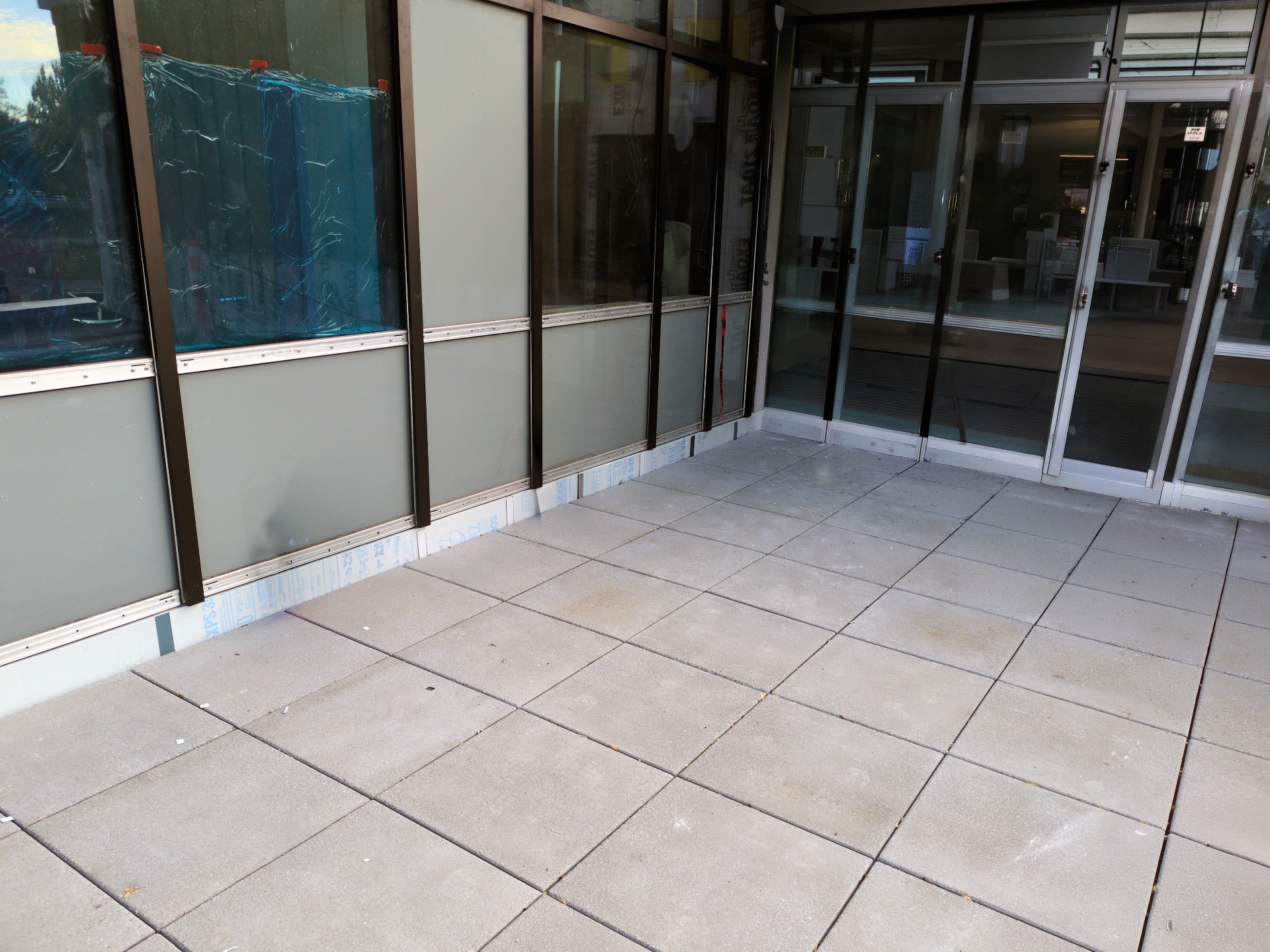 Finished pavers at the building entry with sliding doors