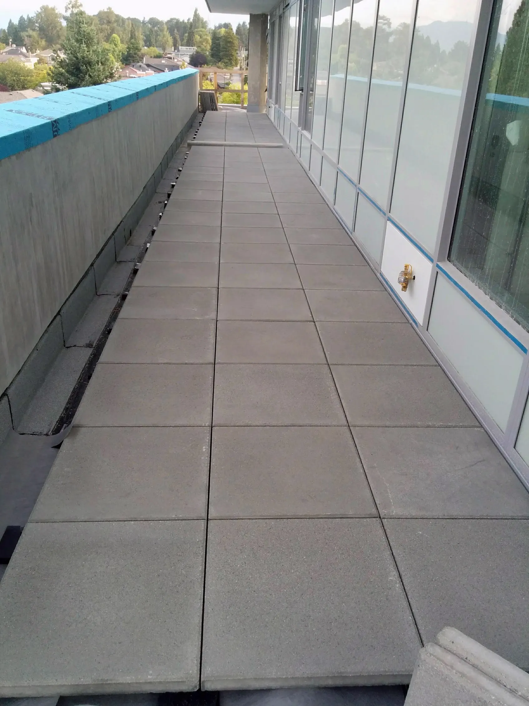 Pedestal slabs over a waterproofed deck