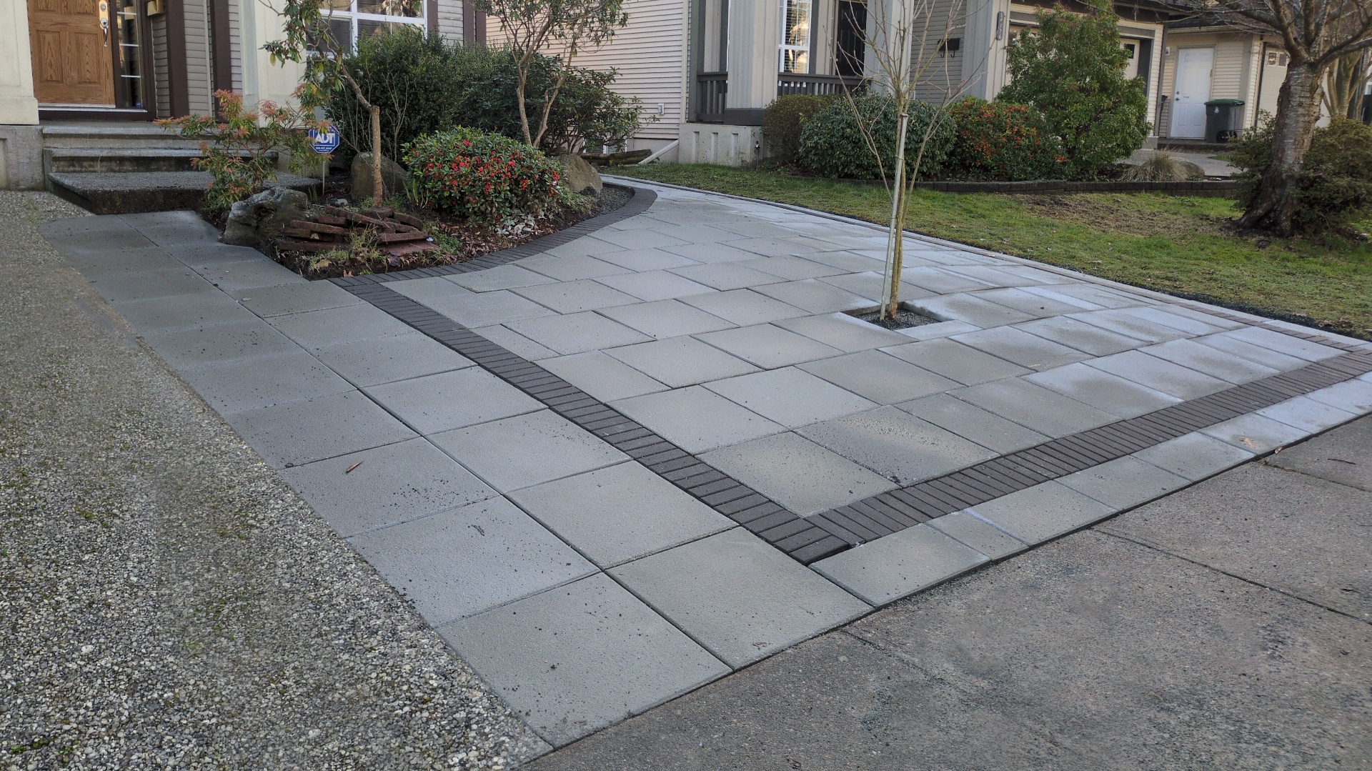 Surrey — finished slab driveway with charcoal perimeter banding and tree well